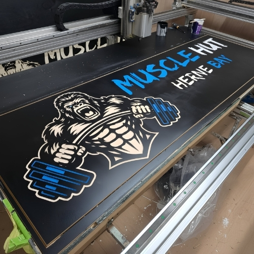 Large printed business sign being produced on CNC machine